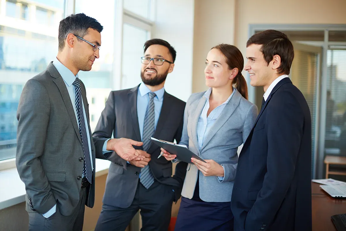 Professionals in business attire discussing.